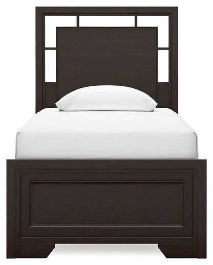 Single bed with a dark wood frame and a white mattress, featuring a simple, modern headboard.