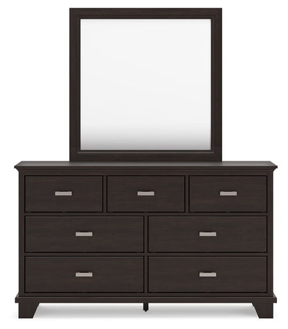Dark wood dresser with seven drawers and a rectangular mirror above.