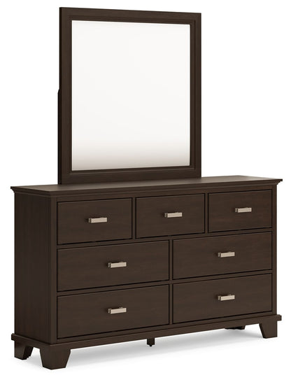 Dark wood dresser with seven drawers and a rectangular mirror above.