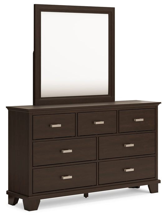Dark wood dresser with seven drawers and a rectangular mirror above.